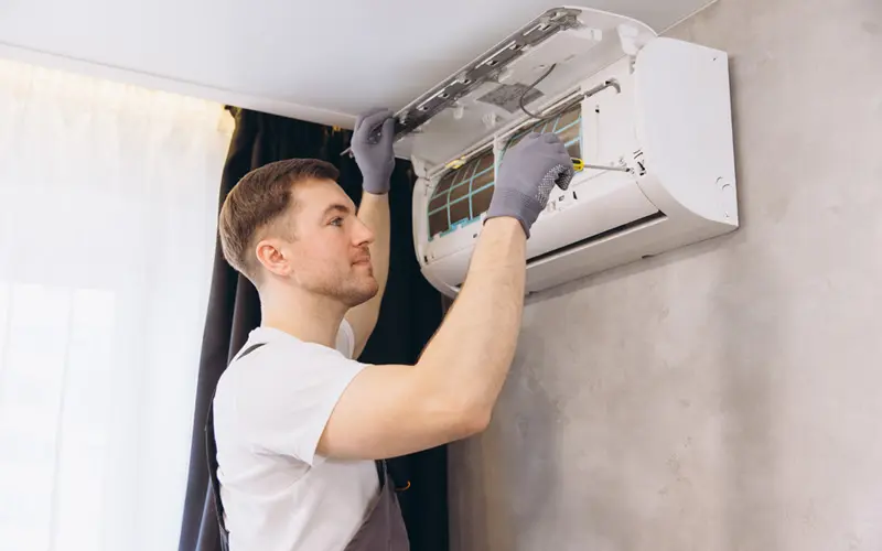 Air Conditioning Repair Image 2_Reduced Technician working on an inside air conditioning unit