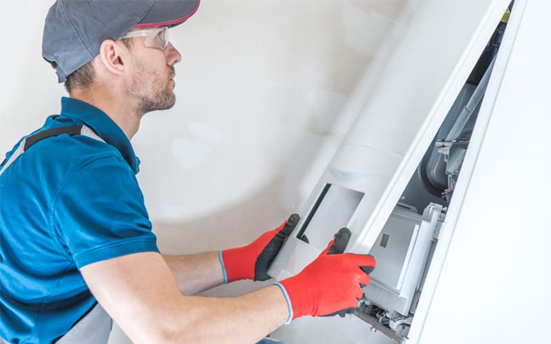 Technician repairing a furnace